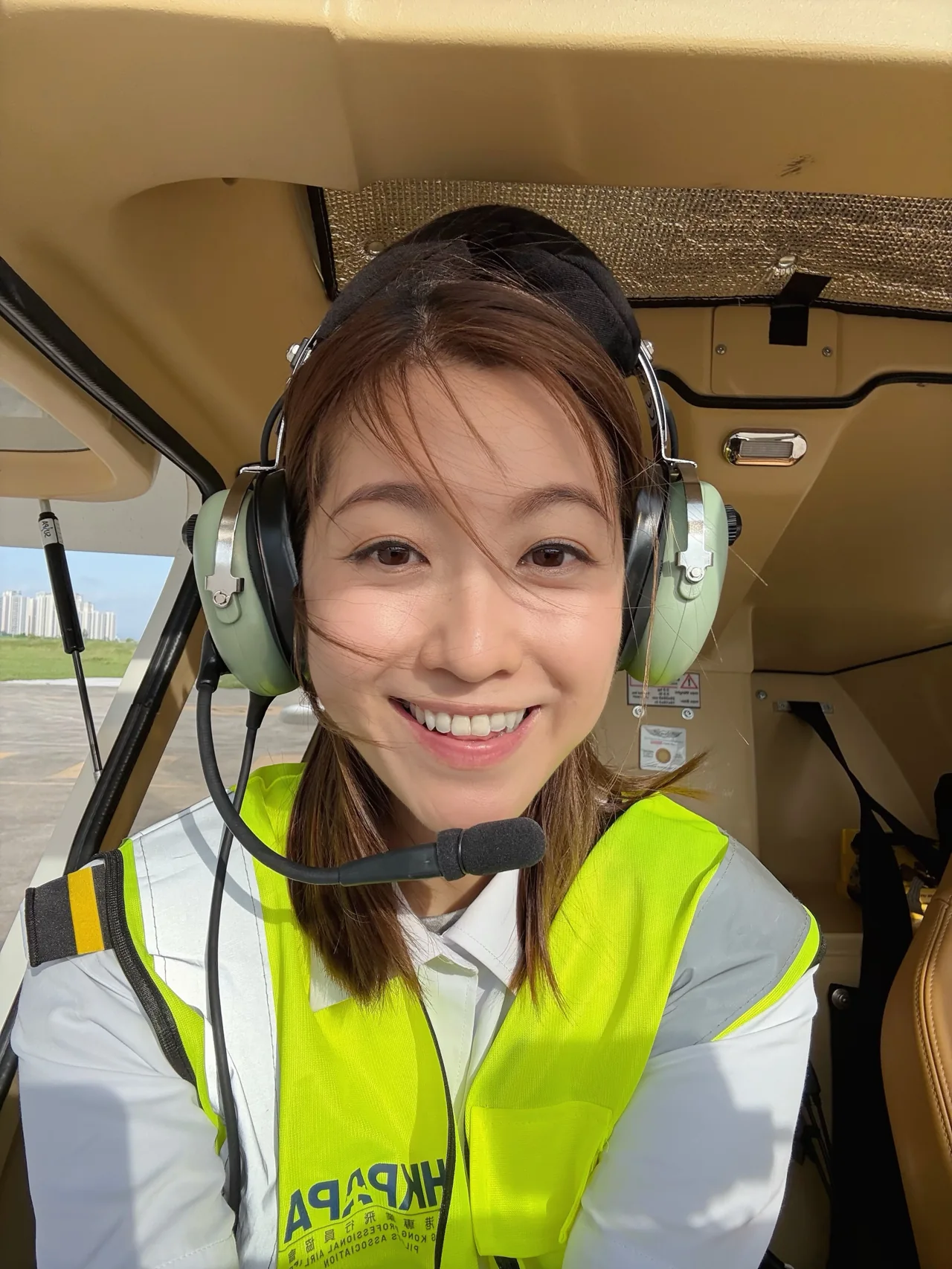 Yoyo wearing her headset in the cockpit