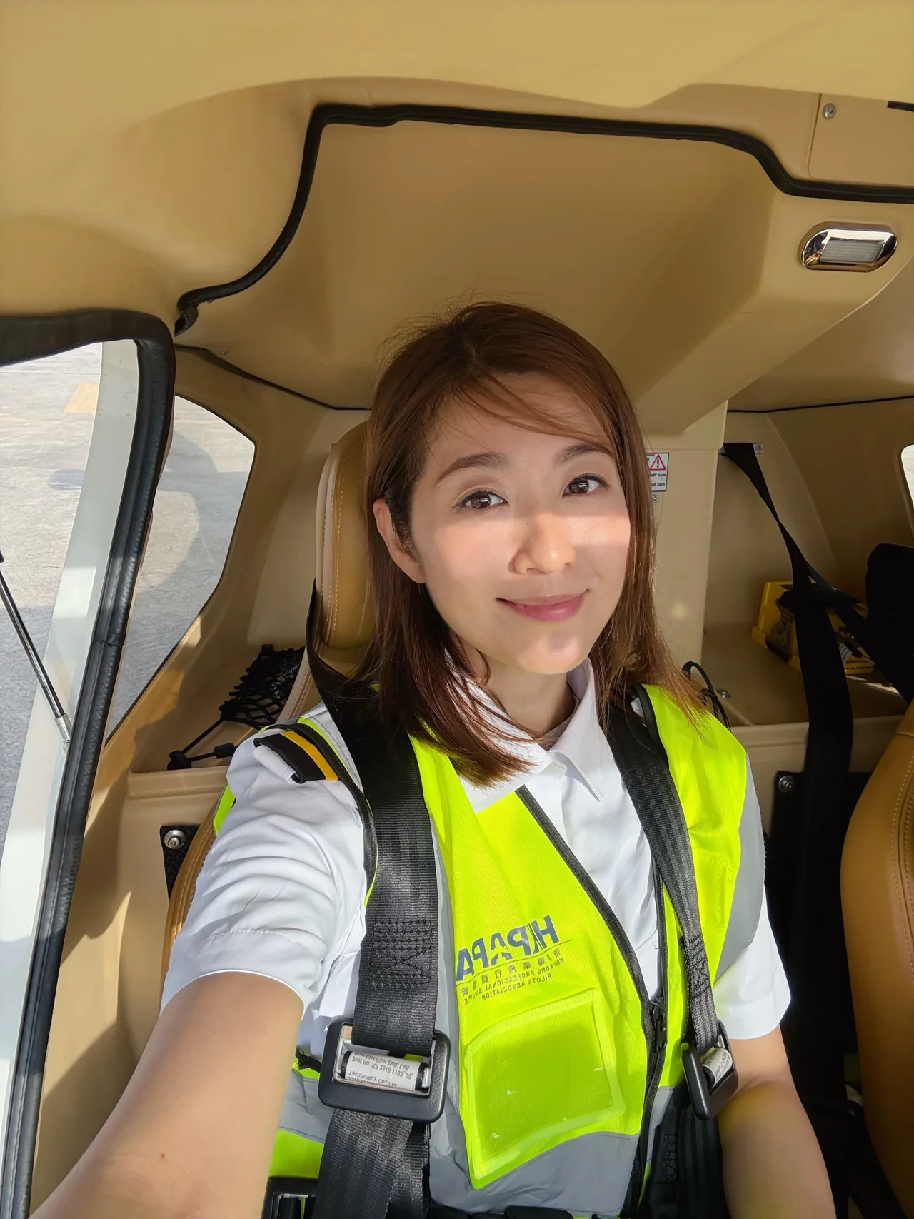 A cockpit selfie in her high-visibility vest