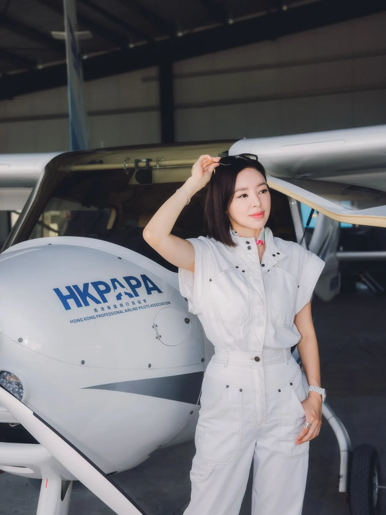 Zoie beside the HKPAPA aircraft in the hangar
