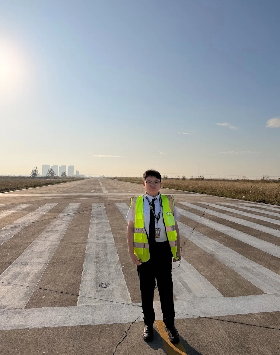 HKPAPA representative beside a training aircraft and Ferrari