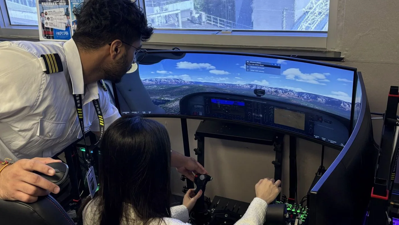 Women and an instructor in a flight simulator